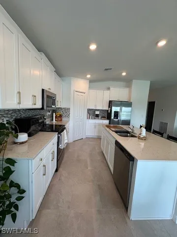 a large kitchen with stainless steel appliances