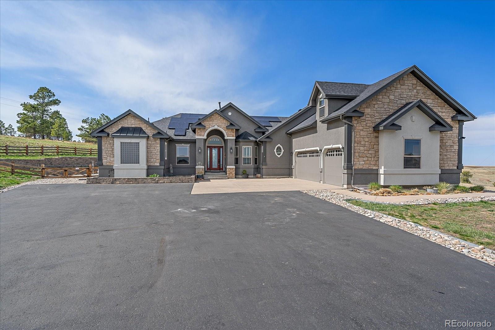 575 Howling Circle Elizabeth, CO 80107 - Photo 1 of 48 a front view of a house with a yard and garage