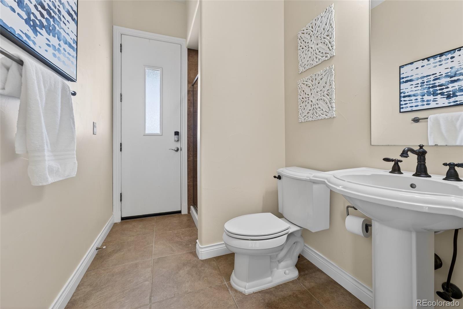 575 Howling Circle Elizabeth, CO 80107 - Photo 20 of 48 a bathroom with a sink toilet and a mirror