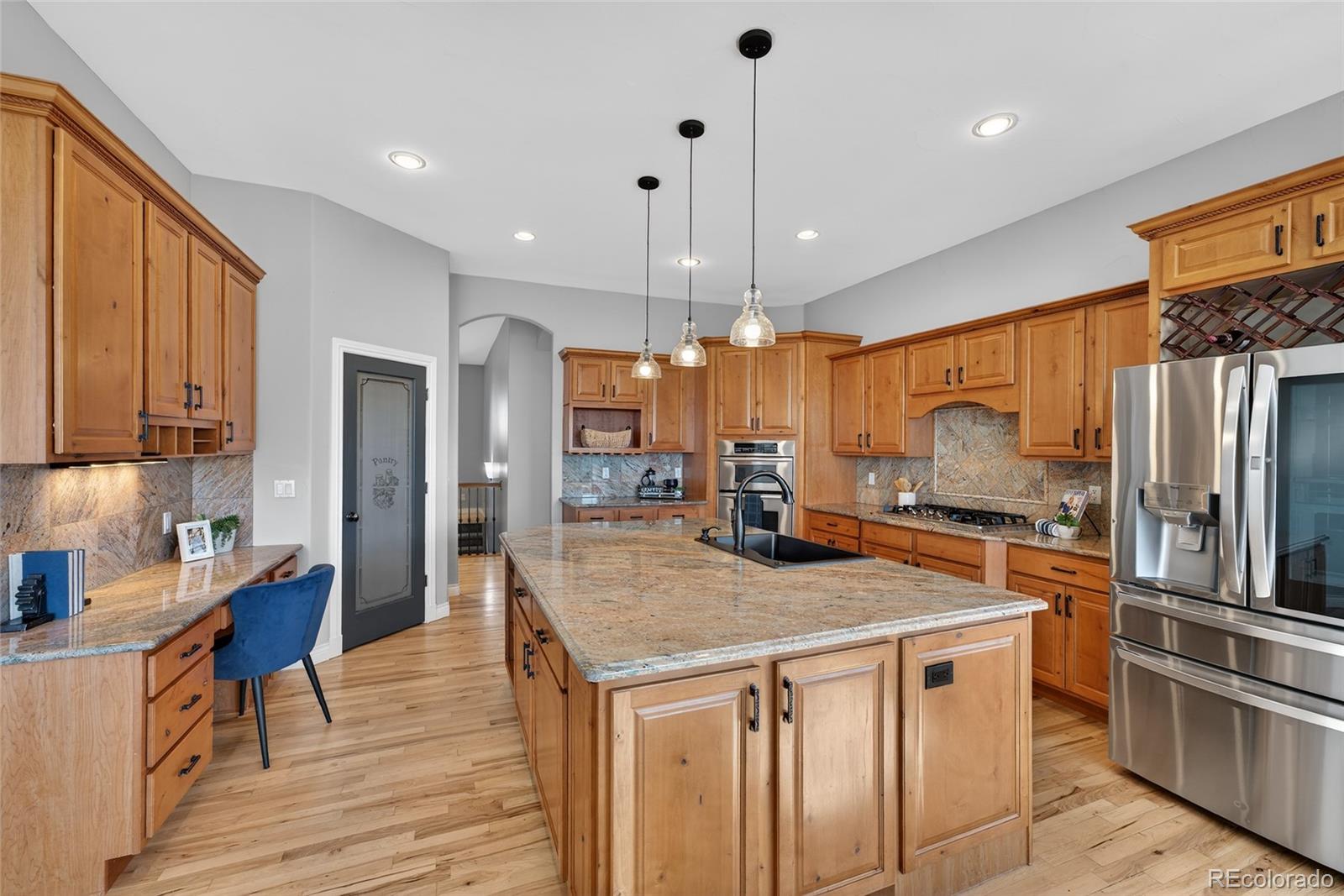 575 Howling Circle Elizabeth, CO 80107 - Photo 24 of 48 a kitchen with stainless steel appliances granite countertop a sink a stove and a refrigerator