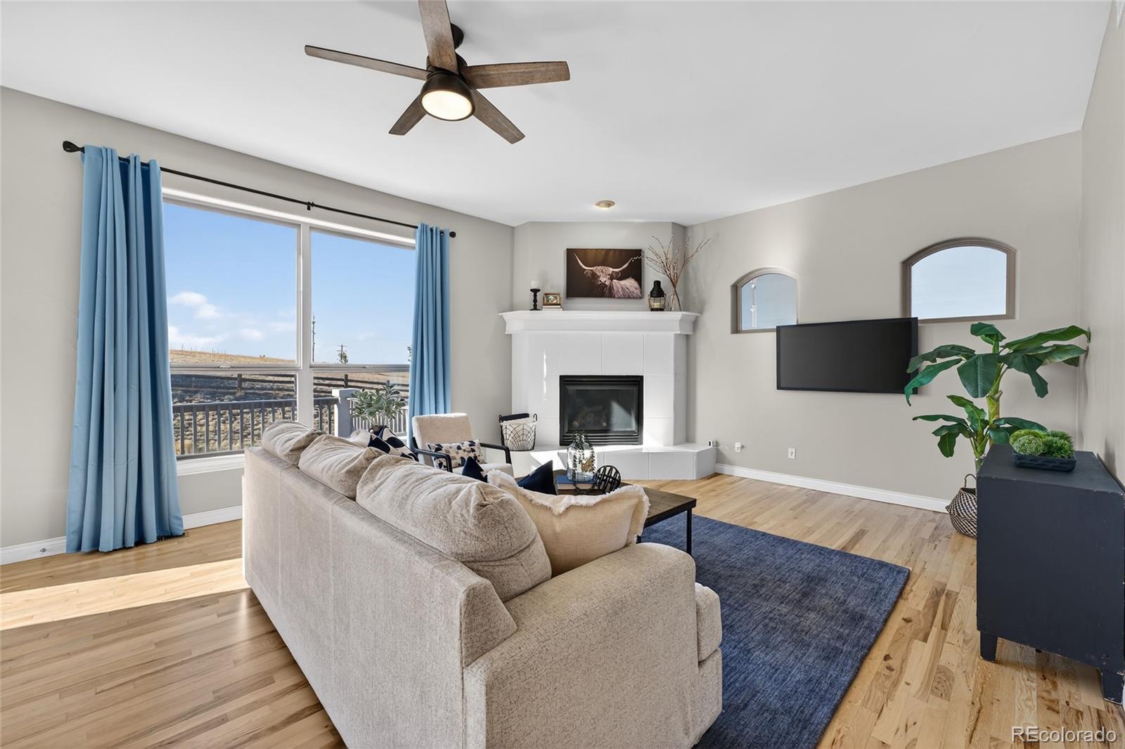 575 Howling Circle Elizabeth, CO 80107 - Photo 25 of 48 a living room with furniture fireplace and a large window