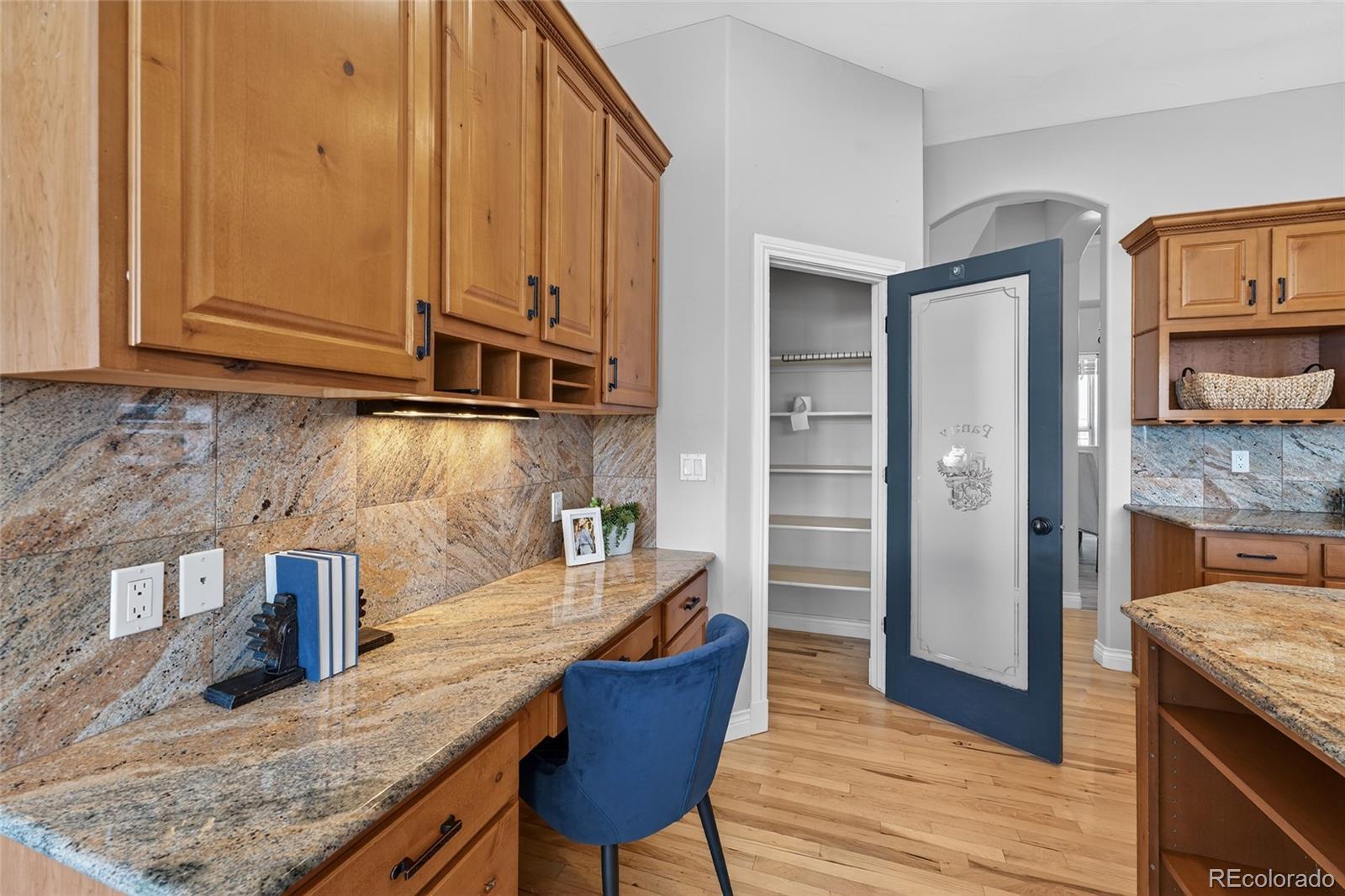 575 Howling Circle Elizabeth, CO 80107 - Photo 28 of 48 a kitchen with granite countertop wooden cabinets and granite counter tops