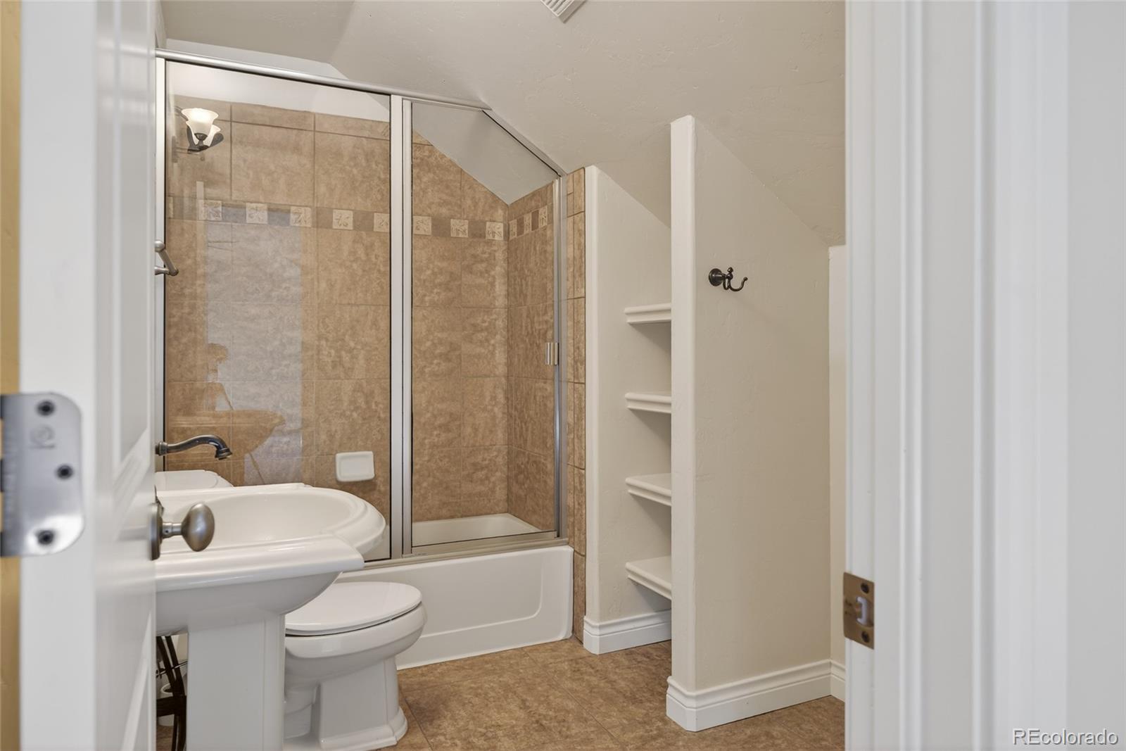 575 Howling Circle Elizabeth, CO 80107 - Photo 34 of 48 a bathroom with a shower a toilet and a sink