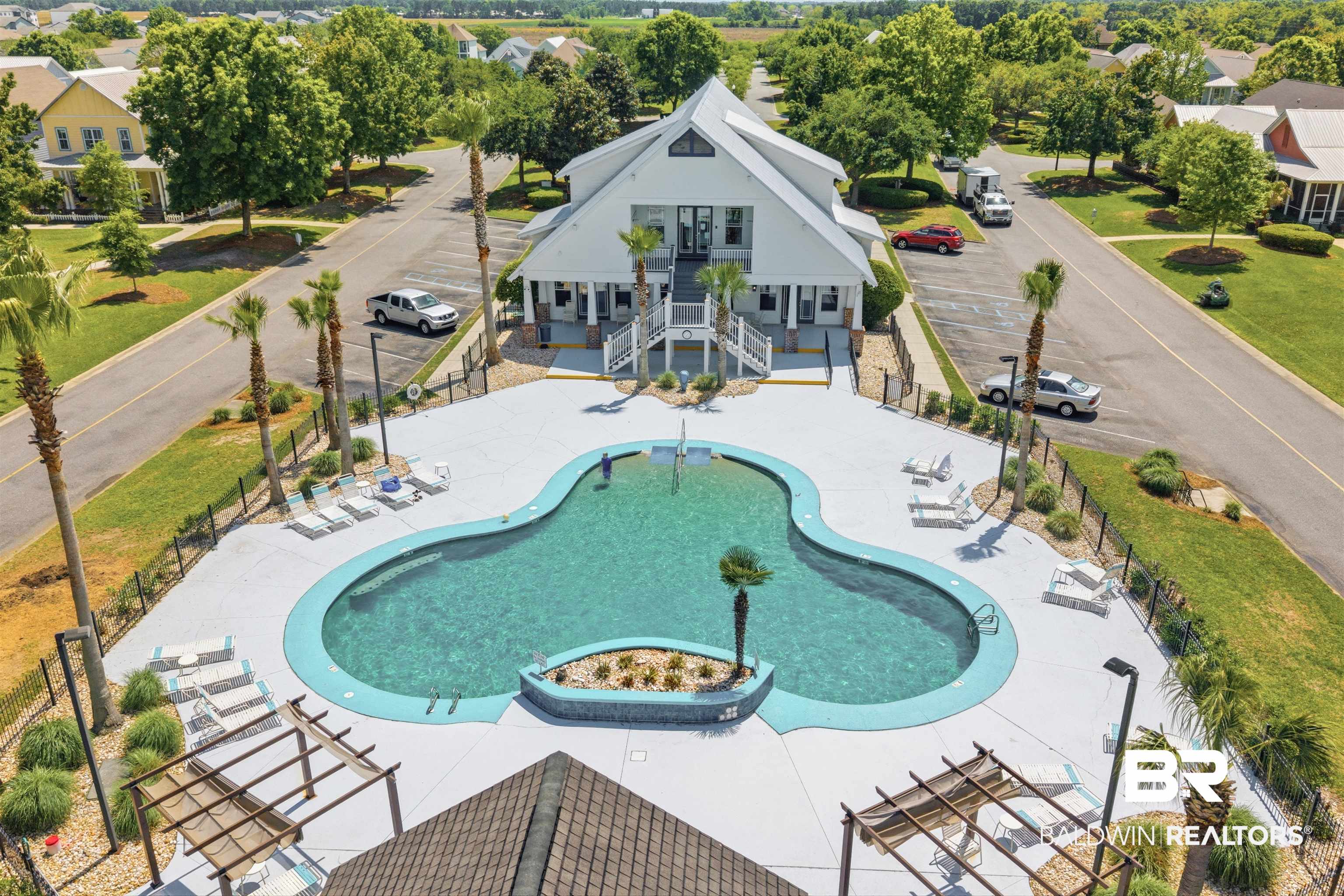 927 Periwinkle Lane Foley, AL 36535 - Photo 19 of 26 Resort-style pool with integrated sun shelf and surrounding concrete decking