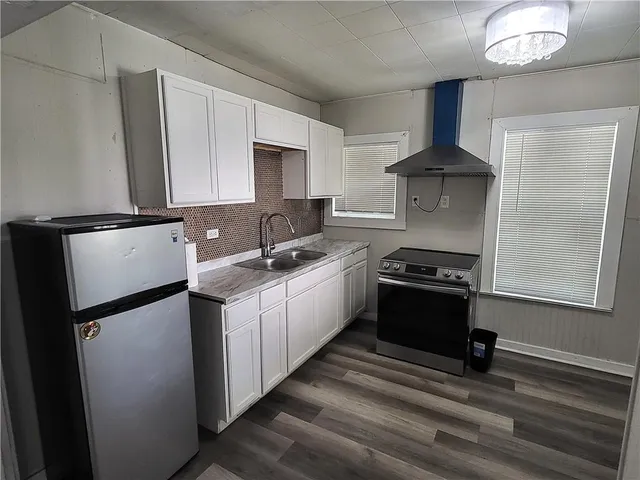 a kitchen with stainless steel appliances a sink stove and refrigerator