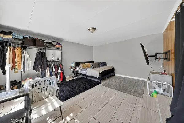 a living room with furniture a flat screen tv and a dining table