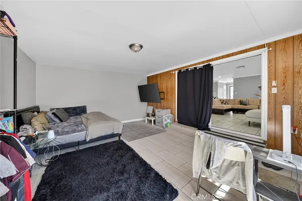 a kitchen with stainless steel appliances granite countertop a refrigerator oven a sink a dining table and chairs with white cabinets