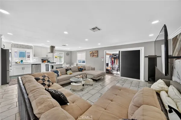 a kitchen with a sink a counter top space and stainless steel appliances