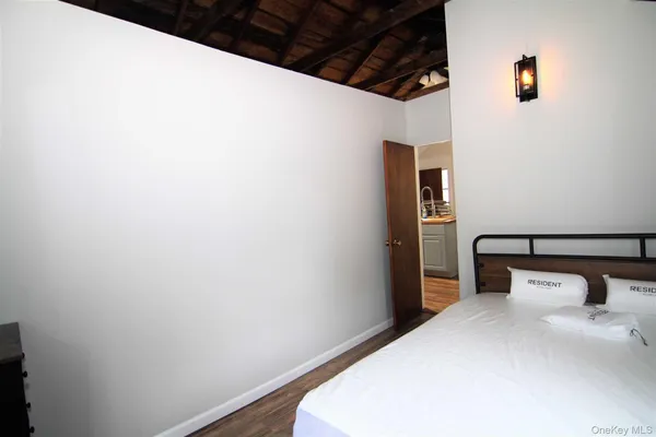 a bedroom with a bed and a night stand