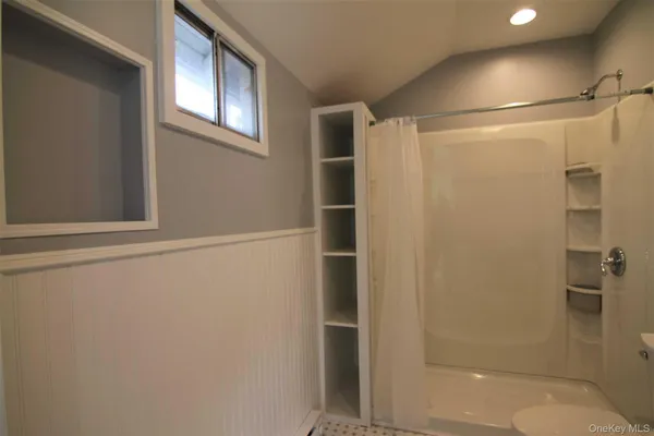 a bathroom with a glass shower door