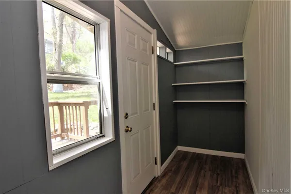 a view of a room with rack on the wall and a window