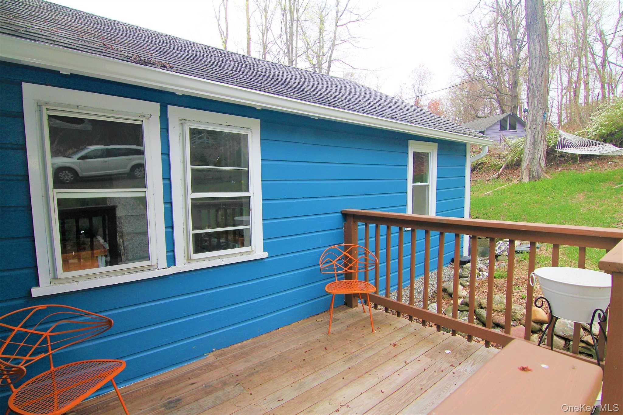71 Miller Road, Unit 12 Hopewell Junction, NY 12533 - Photo 26 of 31 a view of a deck with two chair and a floor to ceiling window