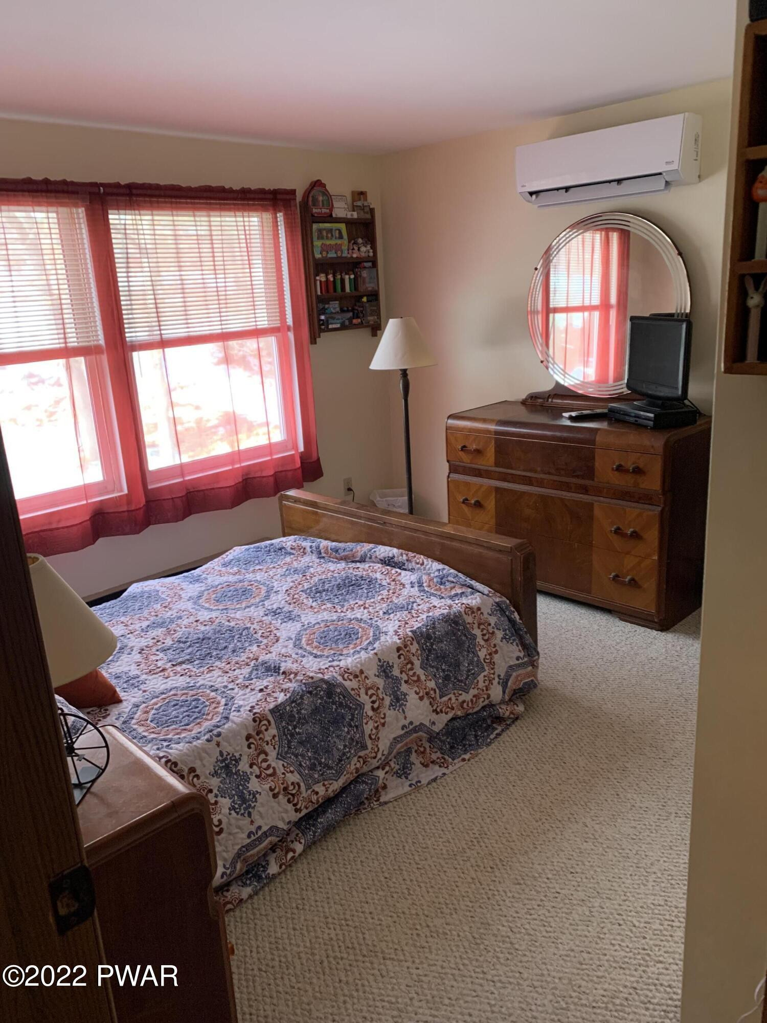 111 Rodeo Lane Hawley, PA 18428 - Photo 8 of 23 a bedroom with a bed and a window
