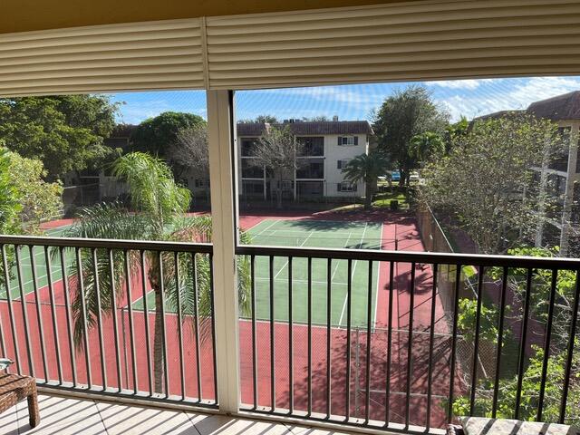 251 South Cypress Road, Unit 146 Pompano Beach, FL 33060 - Photo 6 of 20 a view of a balcony with a floor to ceiling window and wooden fence