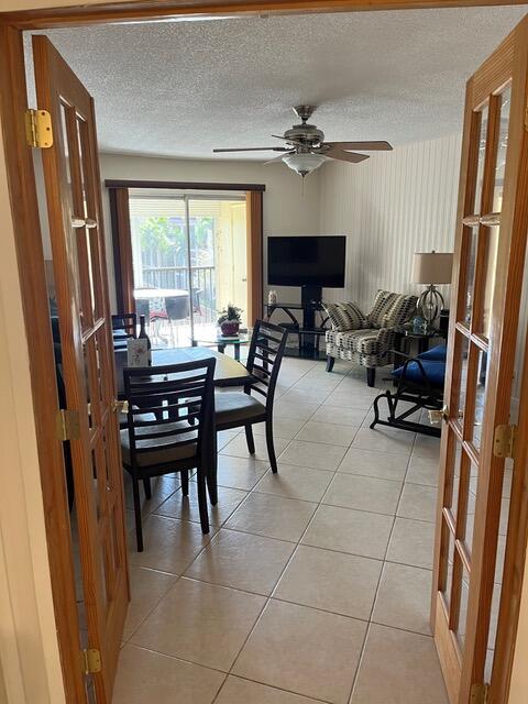 251 South Cypress Road, Unit 146 Pompano Beach, FL 33060 - Photo 9 of 20 a living room with furniture a fireplace and a flat screen tv