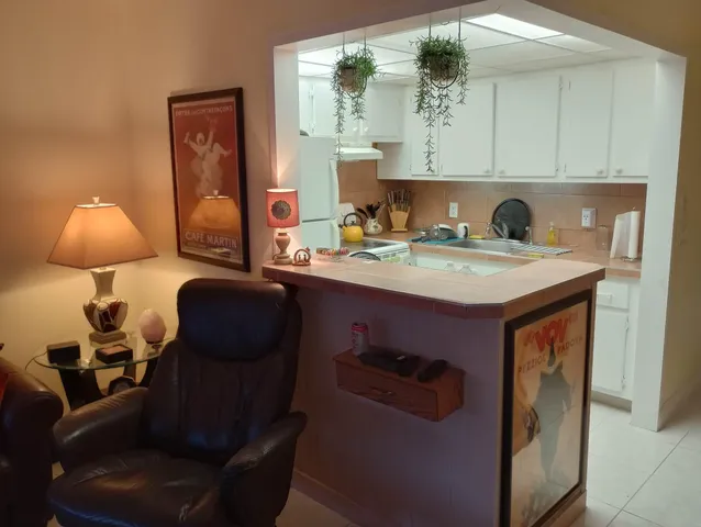 a view of living room with furniture and a mirror