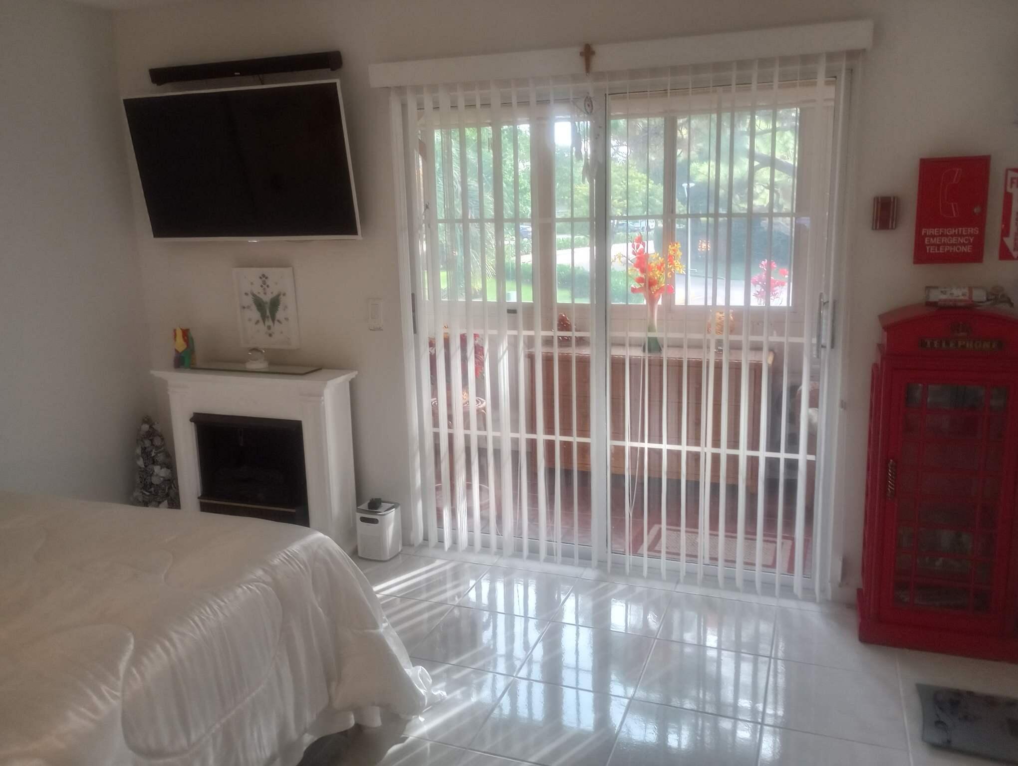 59 Tilford C, Unit 59 Deerfield Beach, FL 33442 - Photo 12 of 39 a bedroom with a bed and a flat screen tv