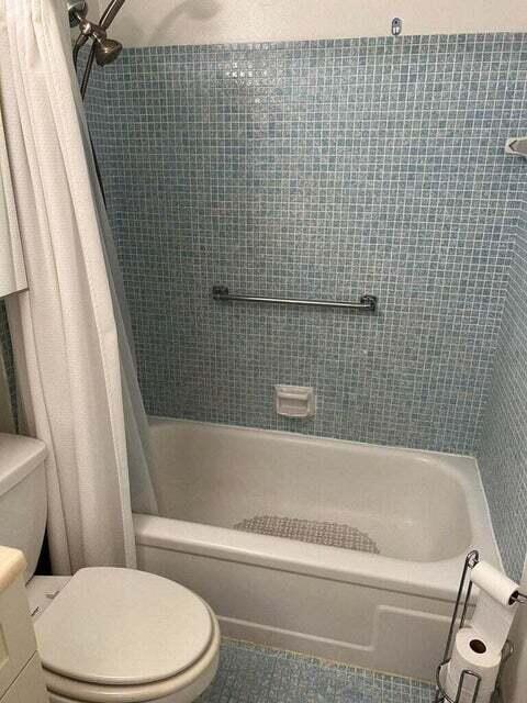 59 Tilford C, Unit 59 Deerfield Beach, FL 33442 - Photo 13 of 39 a bathroom with a white toilet sitting next to a bathtub