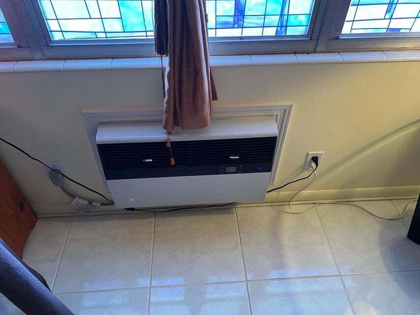 59 Tilford C, Unit 59 Deerfield Beach, FL 33442 - Photo 7 of 39 a view of entryway with a window and wooden floor