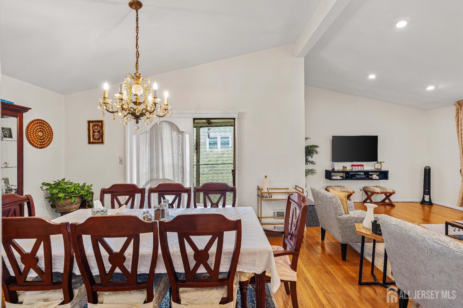 62 Harmon Road Edison, NJ 08837 - Photo 14 of 30 a view of a dining room with furniture a chandelier and wooden floor