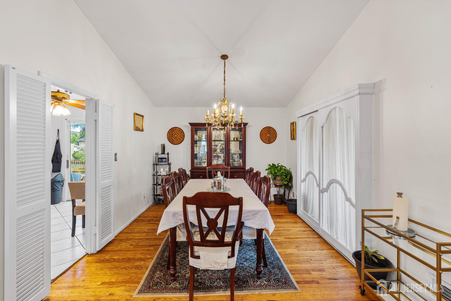 62 Harmon Road Edison, NJ 08837 - Photo 15 of 30 a dining room with chandelier fan and wooden floor