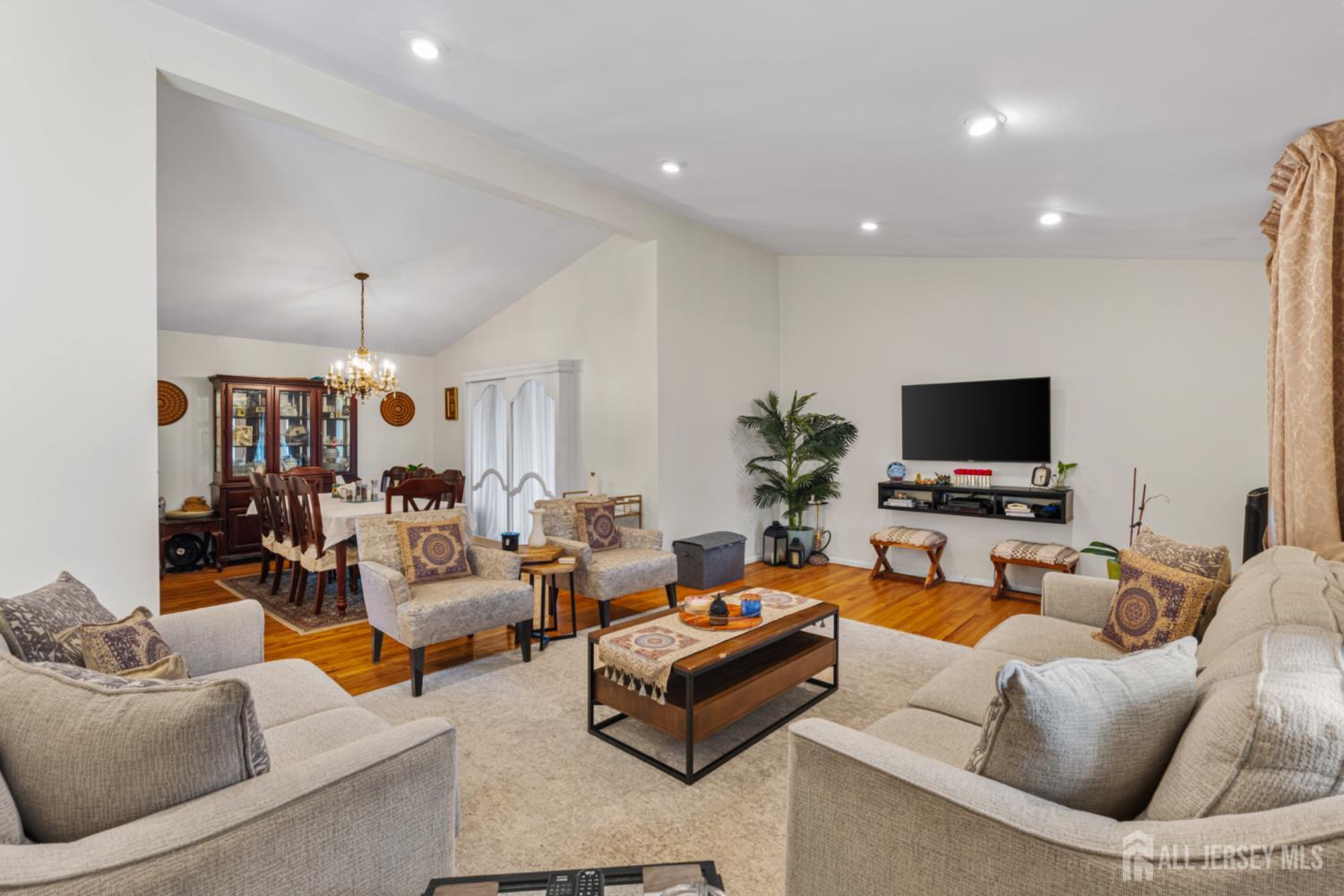62 Harmon Road Edison, NJ 08837 - Photo 16 of 30 a living room with furniture and a flat screen tv