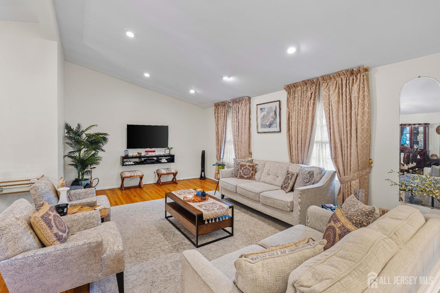 62 Harmon Road Edison, NJ 08837 - Photo 18 of 30 a living room with furniture and a flat screen tv