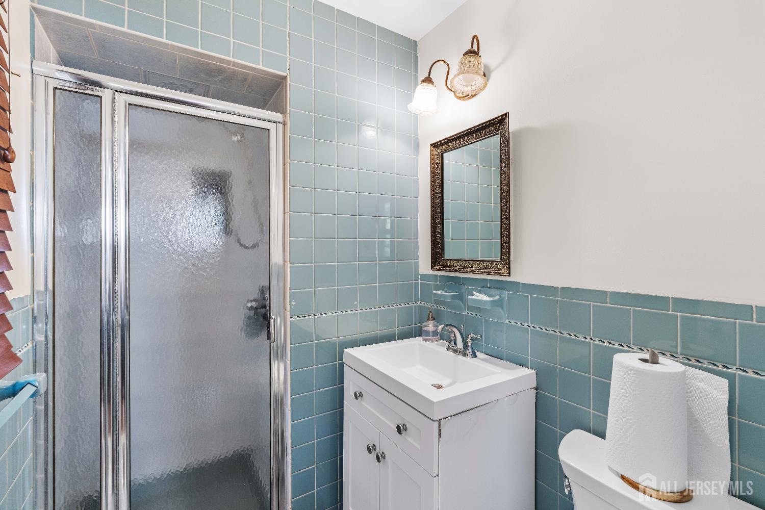 62 Harmon Road Edison, NJ 08837 - Photo 27 of 30 a bathroom with a sink and mirror with toilet