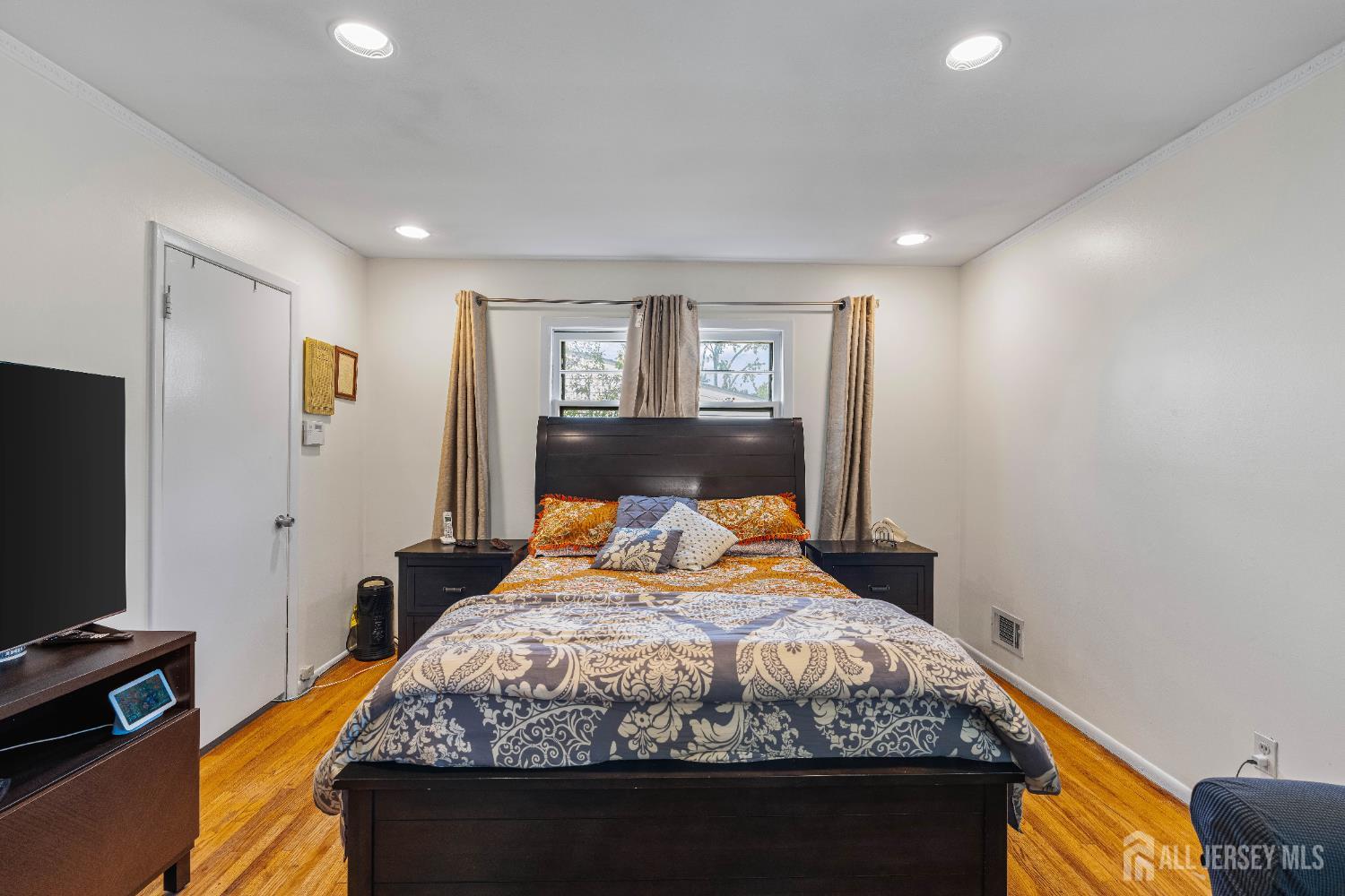 62 Harmon Road Edison, NJ 08837 - Photo 29 of 30 a bedroom with a bed and a flat screen tv