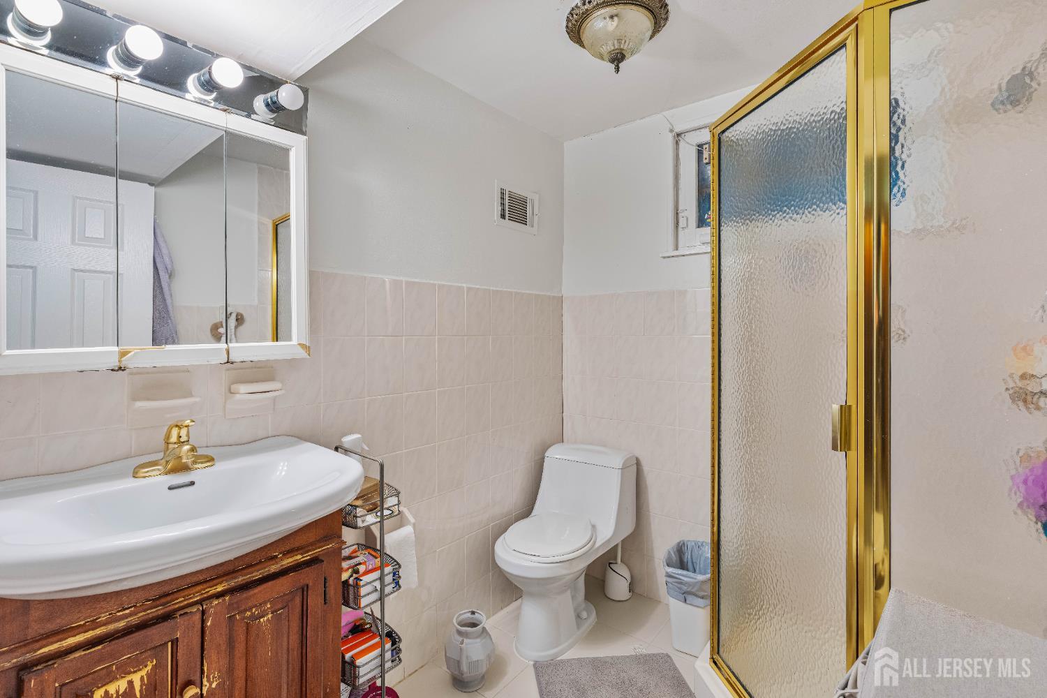 62 Harmon Road Edison, NJ 08837 - Photo 7 of 30 a bathroom with a sink a toilet and shower