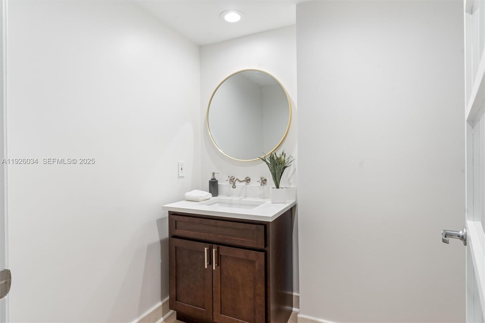333 Las Olas Way, Unit 2406 Fort Lauderdale, FL 33301 - Photo 26 of 55 a bathroom with a sink and a mirror