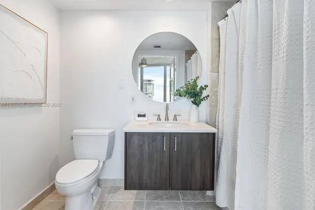 a living room with furniture kitchen view and a chandelier