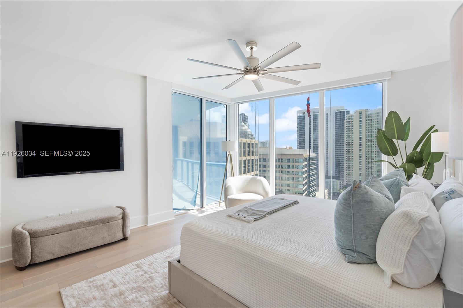 333 Las Olas Way, Unit 2406 Fort Lauderdale, FL 33301 - Photo 36 of 55 a bedroom with a bed a flat screen tv and a couch