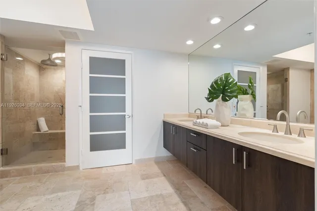 a living room with furniture kitchen view and a wooden floor