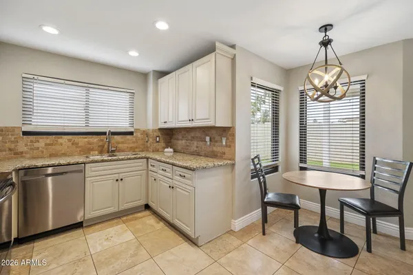 a kitchen with appliances cabinets and a sink