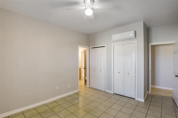 an empty room with windows and closet