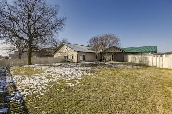 a view of a yard with wooden fence
