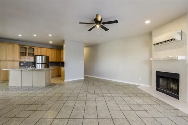 a view of an empty room with window and fireplace