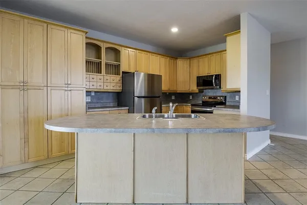 a kitchen with a sink and a refrigerator