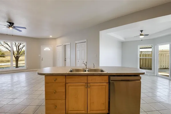 a view of kitchen with stainless steel appliances kitchen island granite countertop a refrigerator and a stove top oven