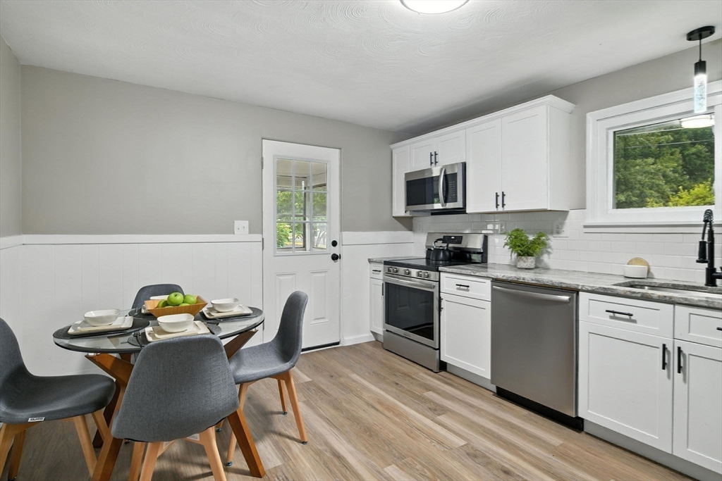 17 Pebble Mill Road Springfield, MA 01118 - Photo 11 of 30 a kitchen with a stove a sink and a microwave