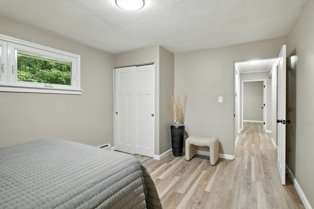 17 Pebble Mill Road Springfield, MA 01118 - Photo 18 of 30 a bedroom with a bed and a table