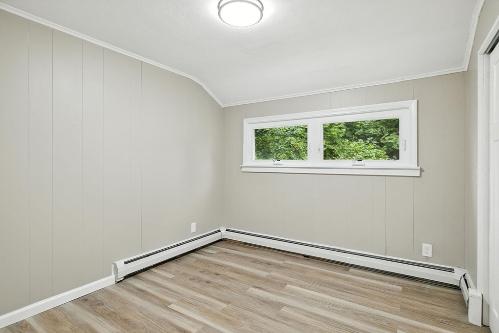 17 Pebble Mill Road Springfield, MA 01118 - Photo 19 of 30 an empty room with wooden floor and windows