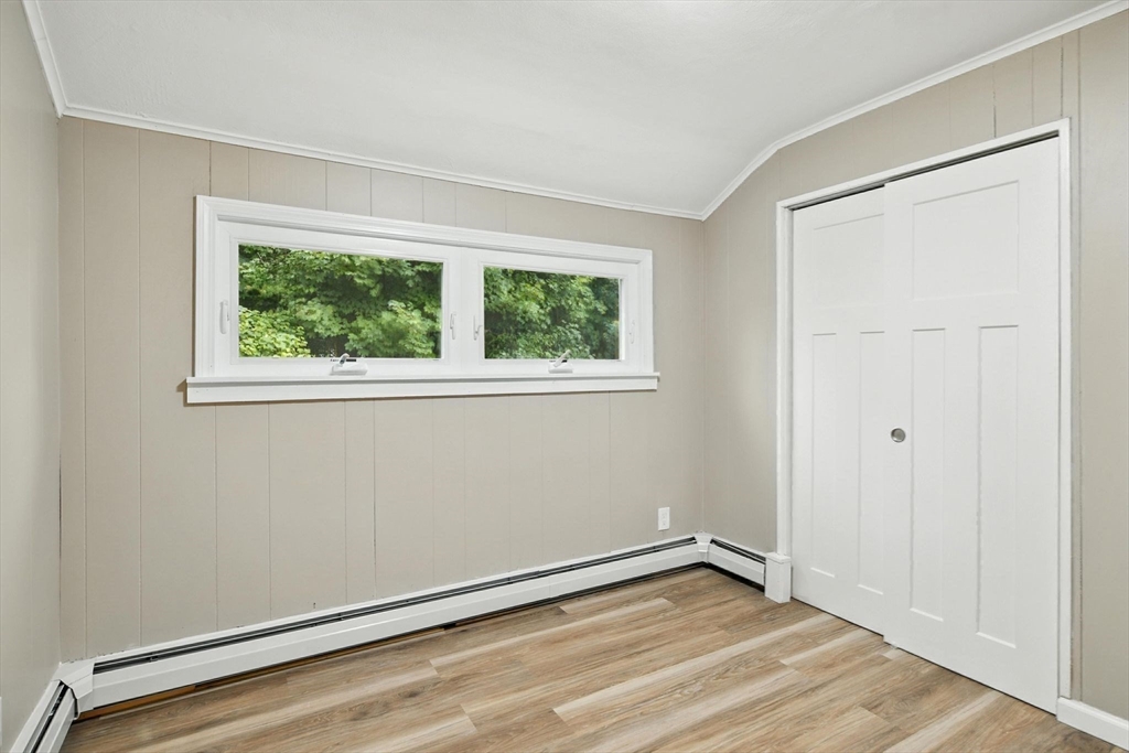 17 Pebble Mill Road Springfield, MA 01118 - Photo 22 of 30 a view of an empty room with wooden floor and a window