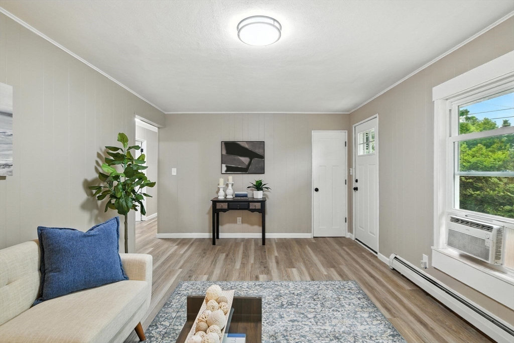 17 Pebble Mill Road Springfield, MA 01118 - Photo 8 of 30 a living room with furniture and a potted plant