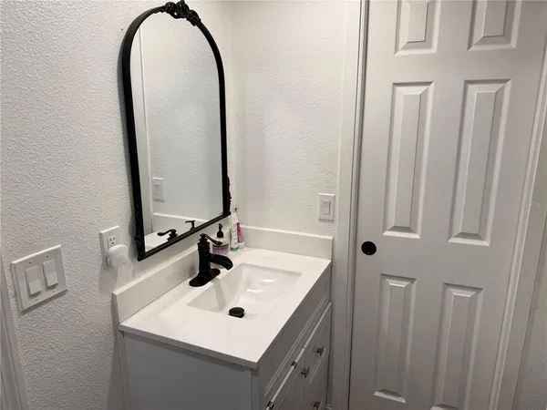 a bathroom with a sink and a mirror