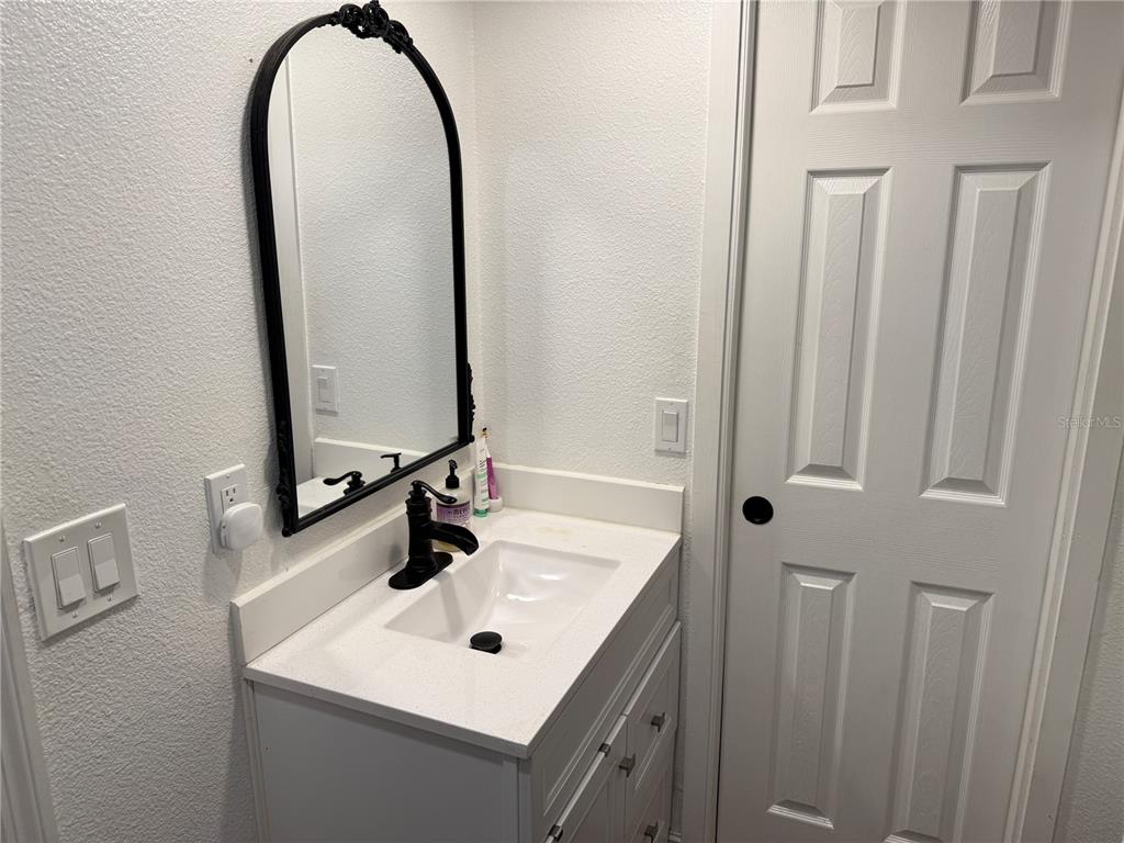10056 Gifford Drive Spring Hill, FL 34608 - Photo 12 of 27 a bathroom with a sink and a mirror