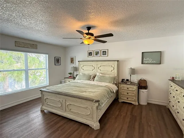 a bedroom with a bed and a large window