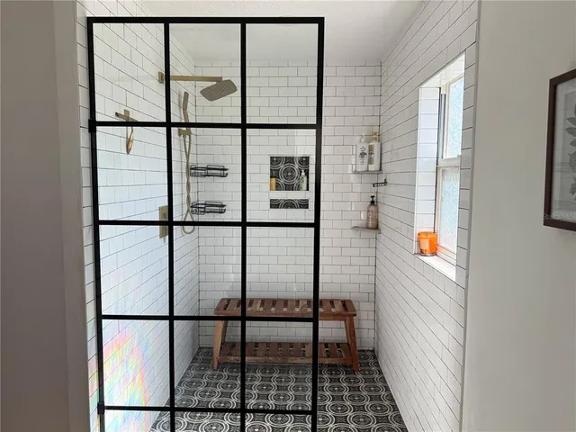 a bathroom with a granite countertop sink a toilet and mirror