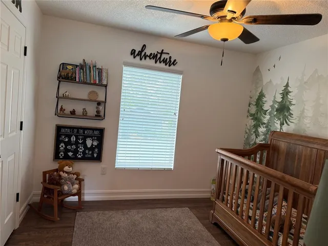 a bedroom with a bed dresser and a window